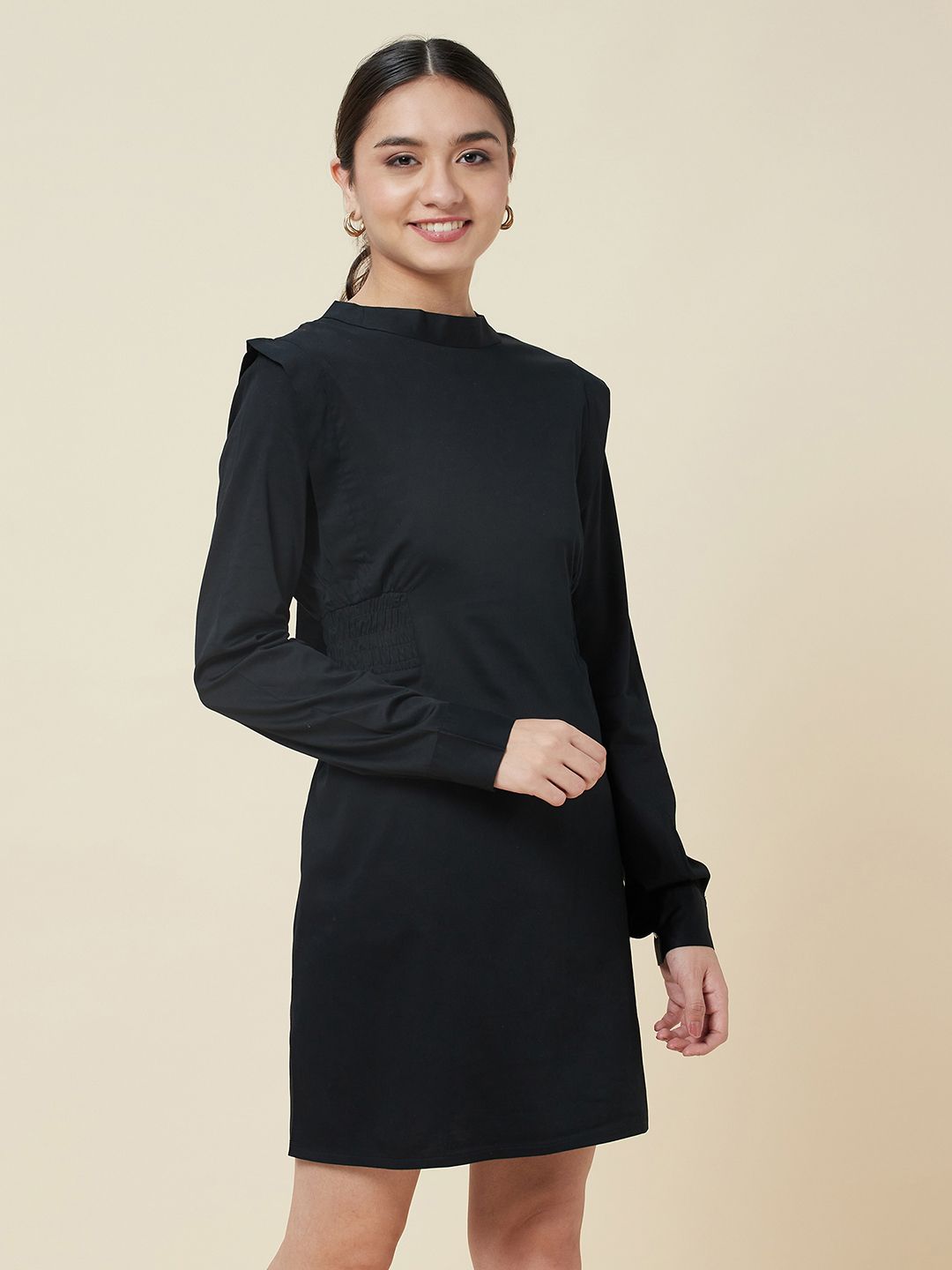 Black high neck dress with side smocking and a belt to cinch the waist