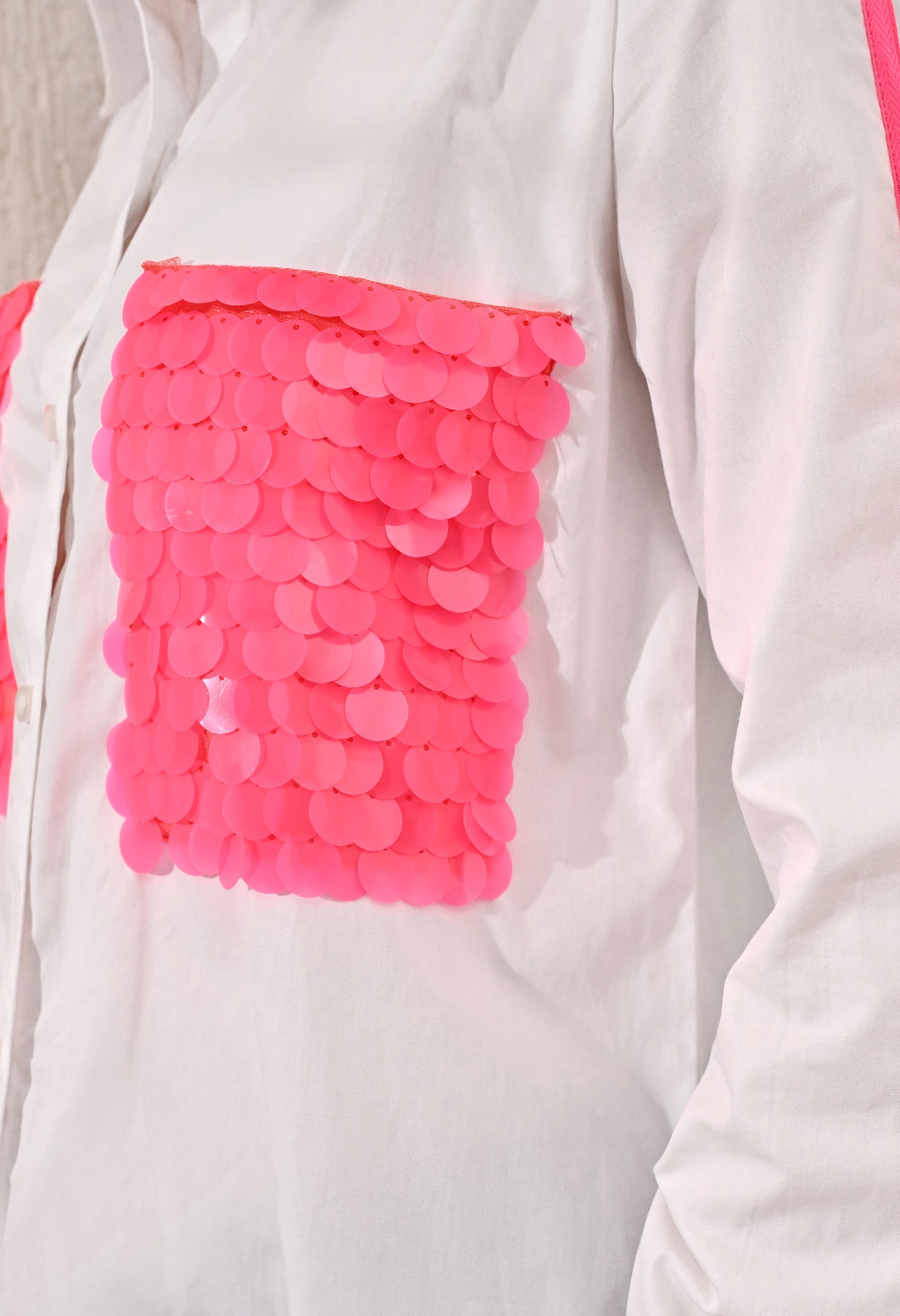 White shirt with neon pink sequence patch pockets